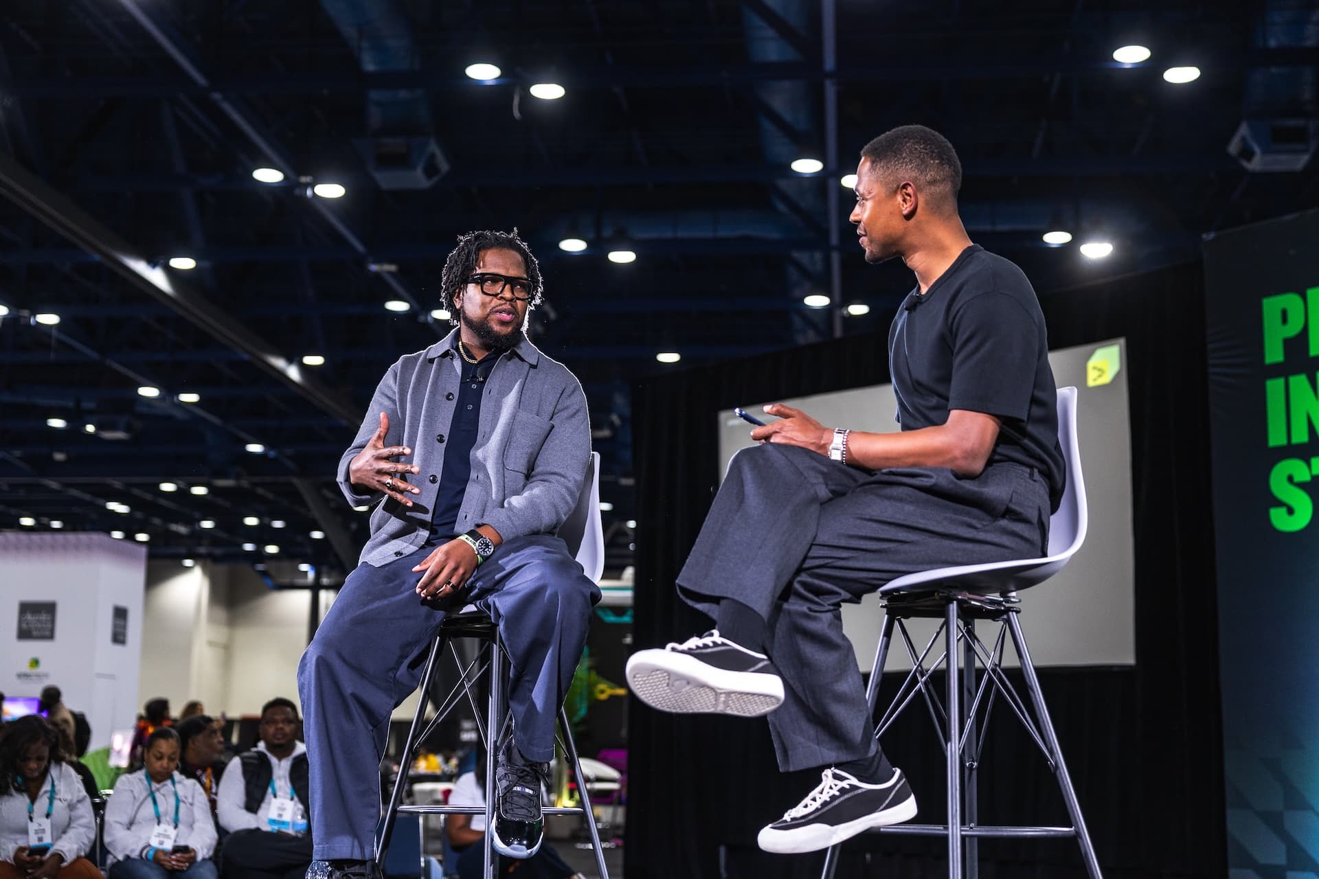 Will Lucas in an Apple Lab interview at AfroTech Conference 2025, sitting across from a guest on stools.